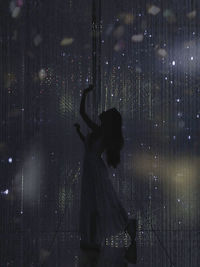 Woman standing on floor at night