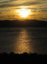 Scenic view of sea against romantic sky at sunset