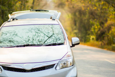 Close-up of car on road