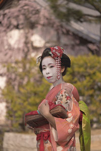 Woman with umbrella standing outdoors