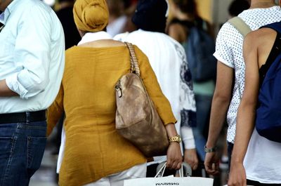 People with bags standing outdoors