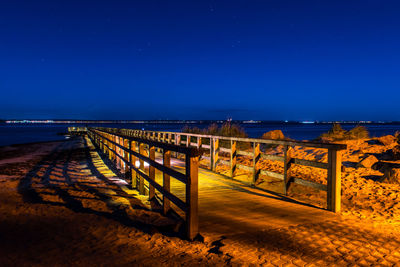 Scenic view of sea against clear blue sky at night