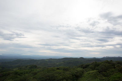 Scenic view of mountains against cloudy sky