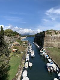 High angle view of boats in river against cloudy sky