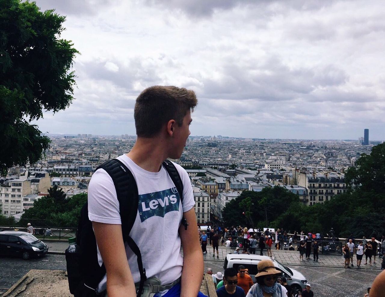 MAN STANDING AGAINST CITYSCAPE IN CITY