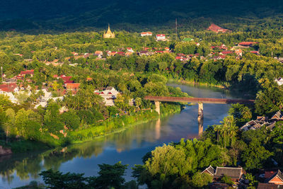 Scenic view of lake amidst trees and buildings