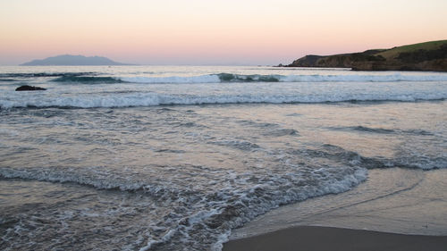 Scenic view of sea against clear sky during sunset