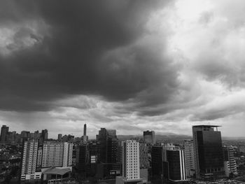 View of cityscape against cloudy sky