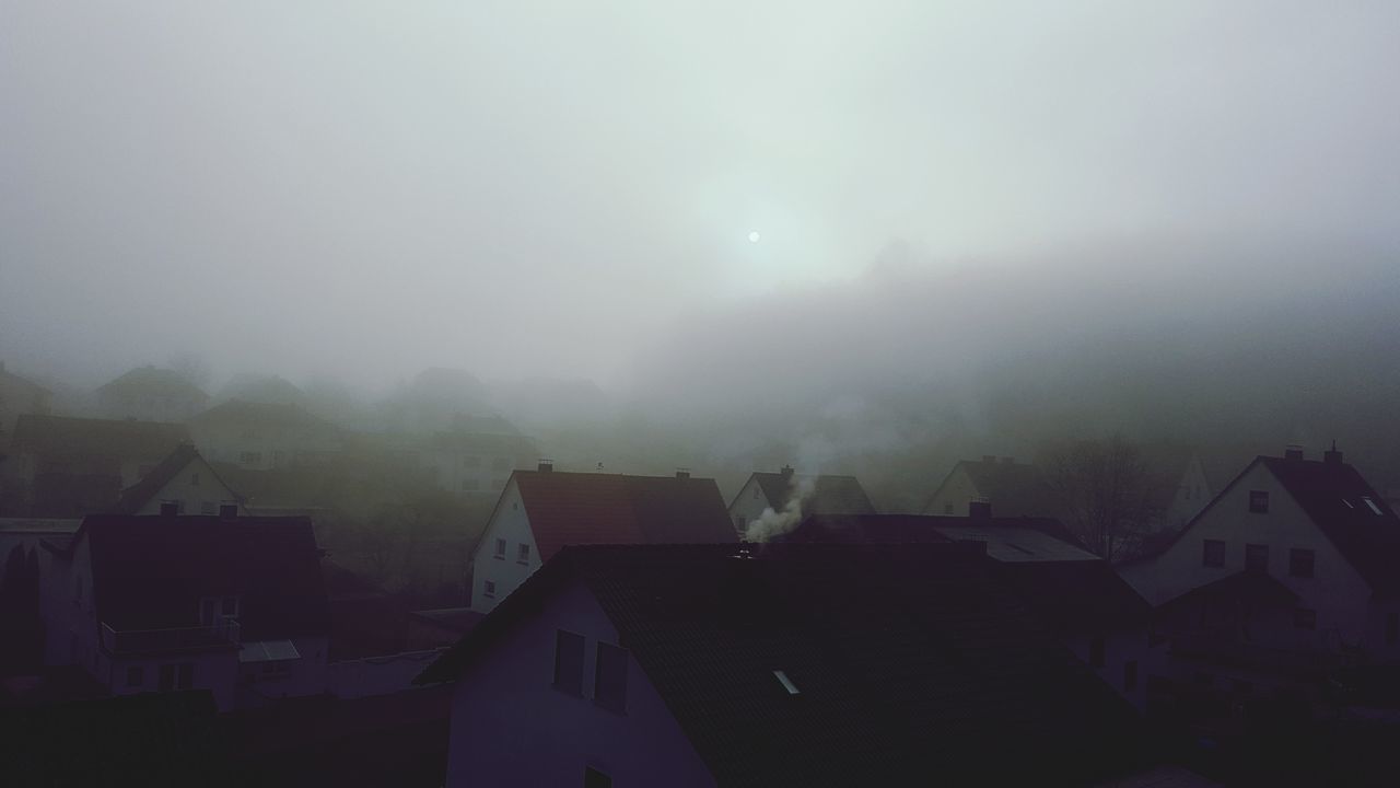 fog, architecture, built structure, building exterior, house, building, sky, residential district, roof, no people, nature, outdoors, city, environment, copy space, town, cloud - sky, day, mountain, hazy, townscape