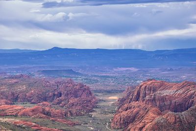 Aerial view of dramatic landscape against cloudy sky