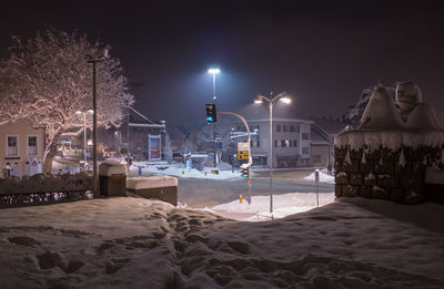 Snow covered sand against sky at night