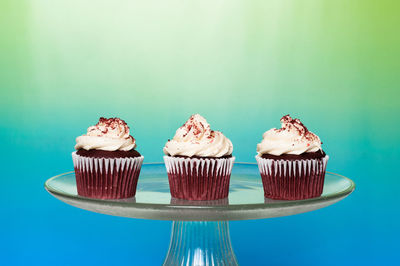 Close-up of cupcakes against blue background