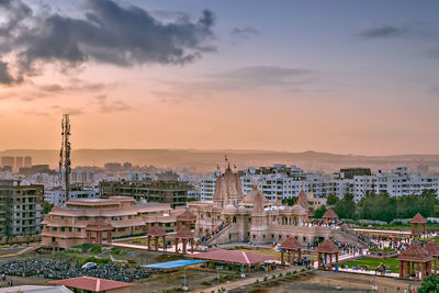 High angle view of buildings against cloudy sky