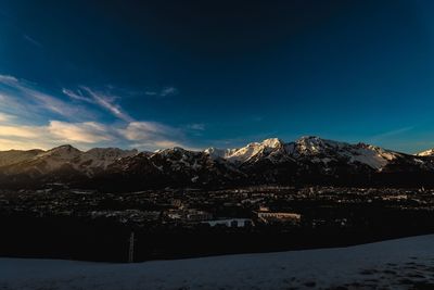 Scenic view of snowcapped mountains against blue sky