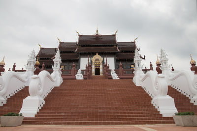 Statue of temple against building