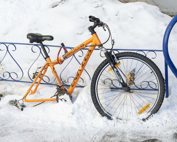 Bicycle parked on snow covered field