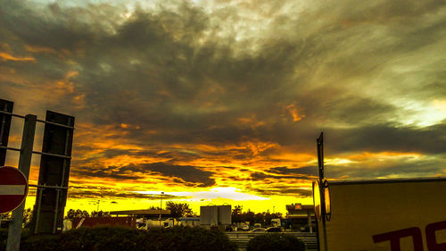 Low angle view of city against dramatic sky