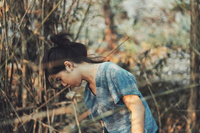 Side view of woman in forest