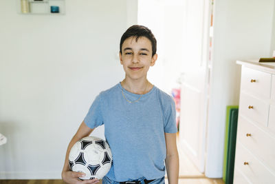 Boy with football at home