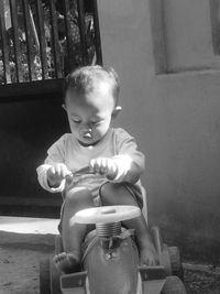 Cute boy sitting outdoors