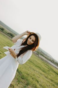 Woman standing on field against sky