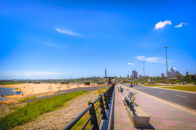 Road by city against sky