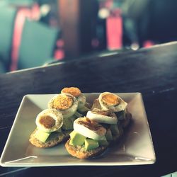 Close-up of bread with eggs in plate on table