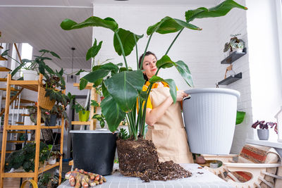 Midsection of woman holding potted plant