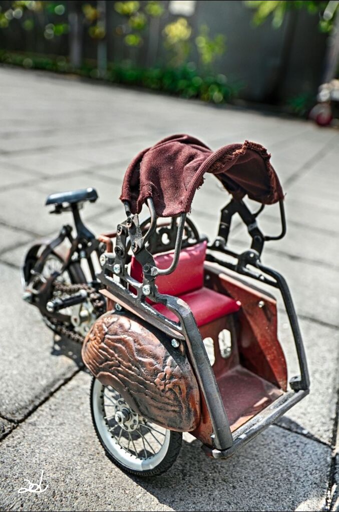 bicycle, focus on foreground, transportation, land vehicle, street, mode of transport, sidewalk, close-up, parking, stationary, day, shadow, road, outdoors, metal, no people, sunlight, wheel, high angle view, parked