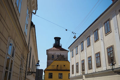 Low angle view of buildings against clear blue sky