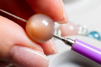 Cropped hand holding dental equipment