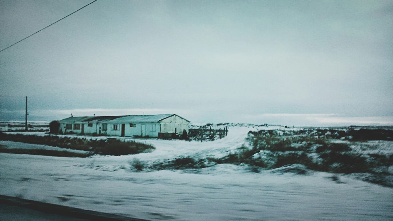 snow, winter, cold temperature, built structure, architecture, water, weather, season, building exterior, sky, frozen, house, nature, covering, scenics, sea, tranquil scene, beauty in nature, landscape, clear sky