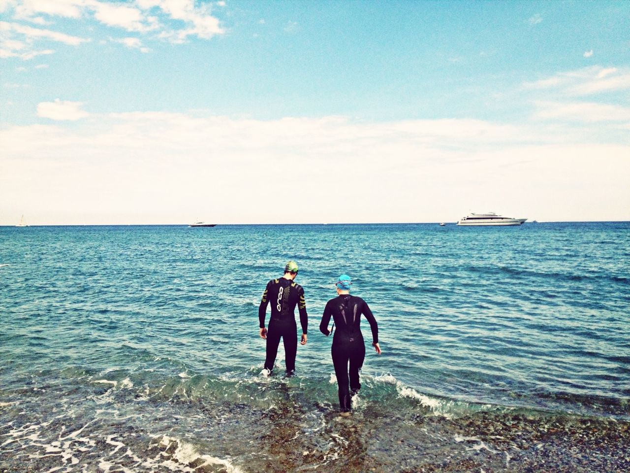 sea, water, lifestyles, horizon over water, leisure activity, men, sky, rear view, togetherness, beach, person, full length, vacations, shore, travel, standing, weekend activities, nature