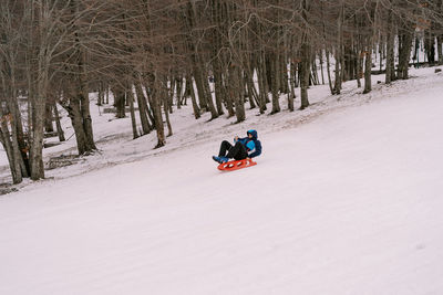 People skiing on snow covered field