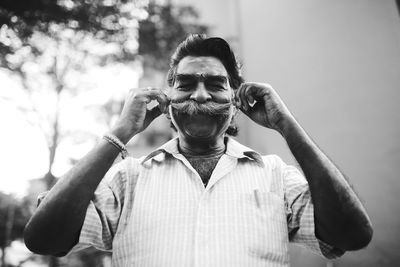 Portrait of man wearing sunglasses standing outdoors