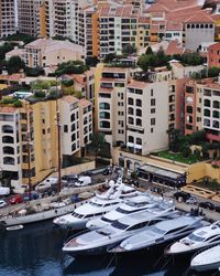 Boats moored in canal against buildings in city