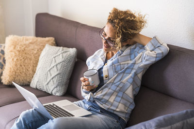 Young woman using laptop at home