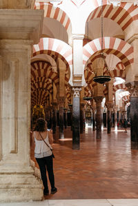 Rear view of woman walking in corridor