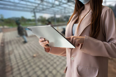 Midsection of woman using mobile phone