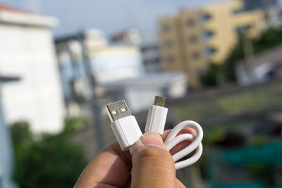 Close-up of hand holding cable