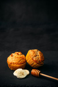 Close-up of cupcakes against black background