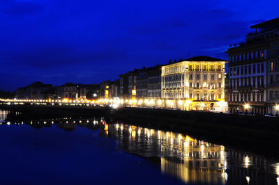 Night view of townscape at the edges of arno river, florence, italy.
