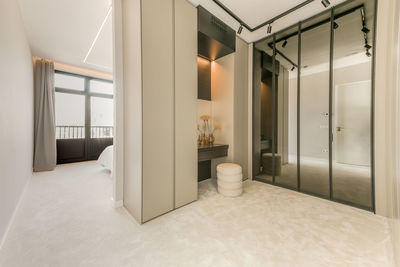 Interior of room with large wardrobe with mirror in contemporary flat in minimal style