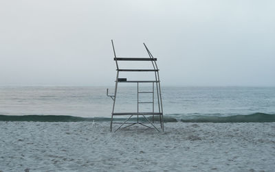 Lifeguard hut on beach against clear sky