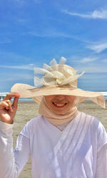 Smile on the beach with a hat