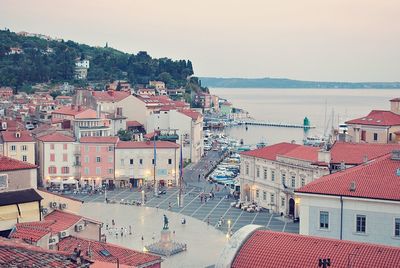 High angle view of townscape by sea against sky