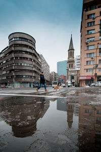 Reflection of buildings in puddle