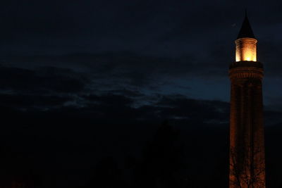 Low angle view of illuminated building against sky at night