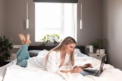 Woman relaxing on bed at home