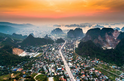 Aerial view of cityscape against sky during sunset